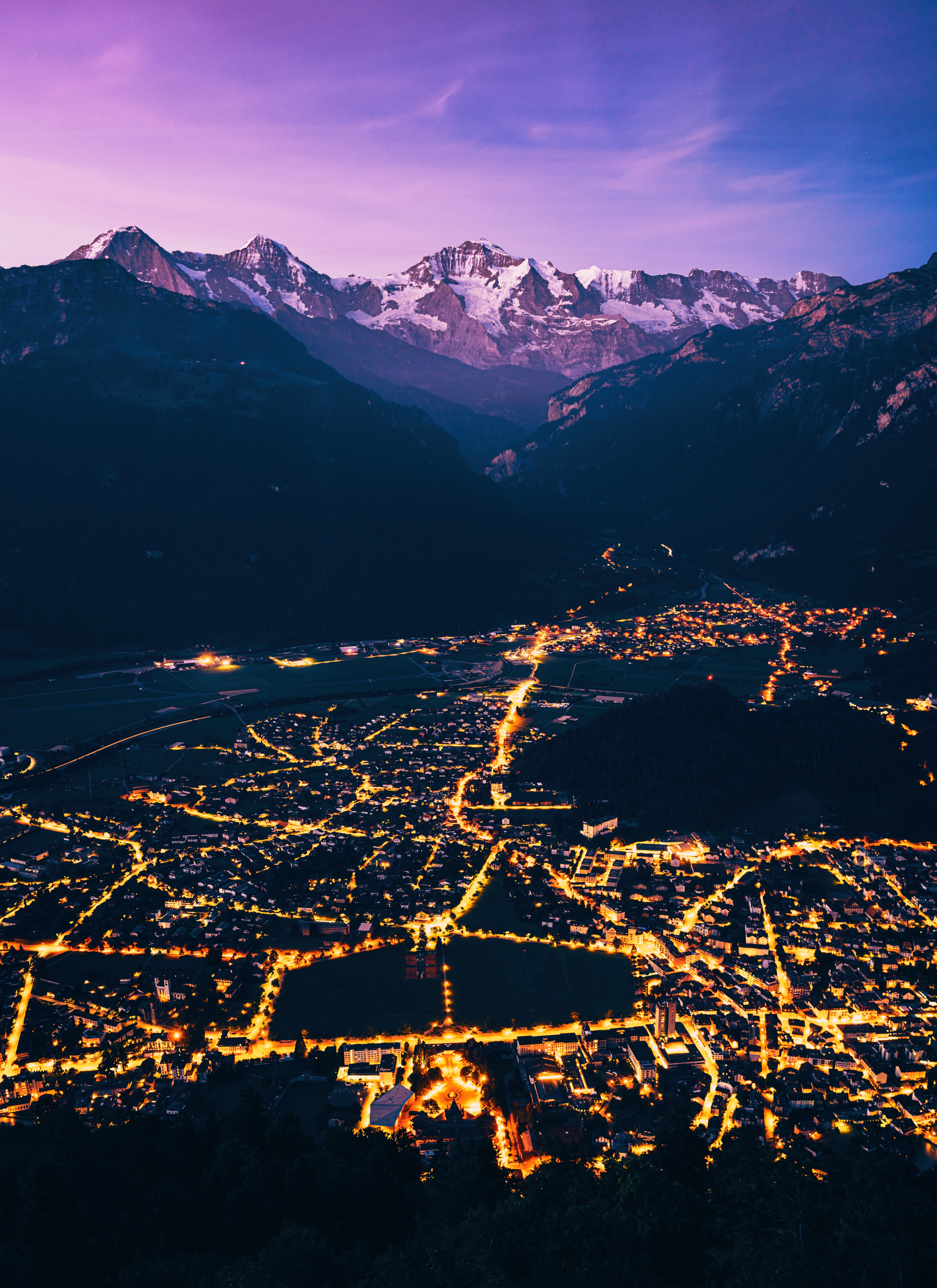 HD wallpaper, 5K, City Lights, Mountain Peak, Purple, Dawn, Aerial View