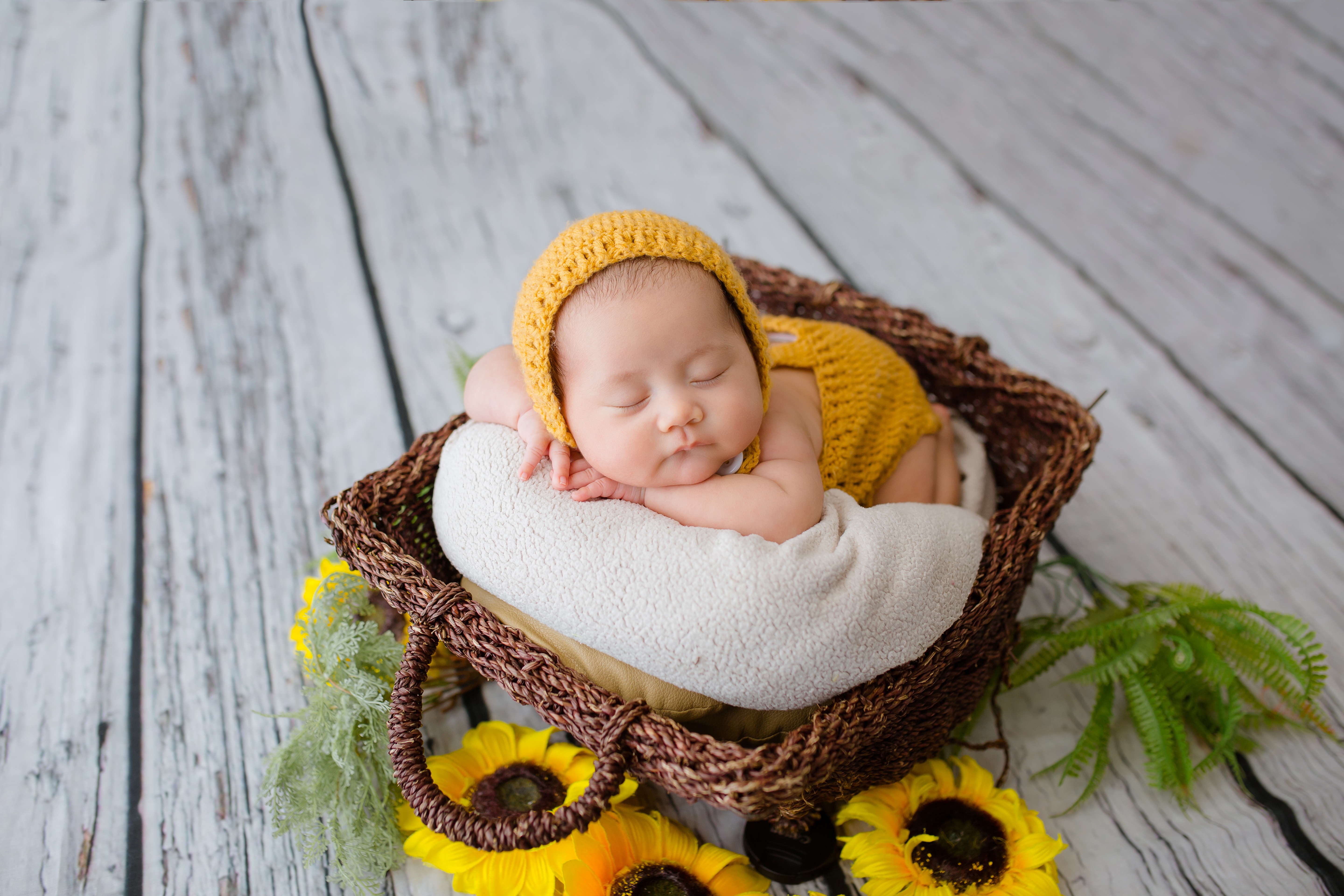 HD wallpaper, Newborn, Basket, Sunflowers, Cute Baby, Yellow Dress, Wooden Floor, Green Leaves, 5K, Crochet Baby Costume, Sleeping Baby