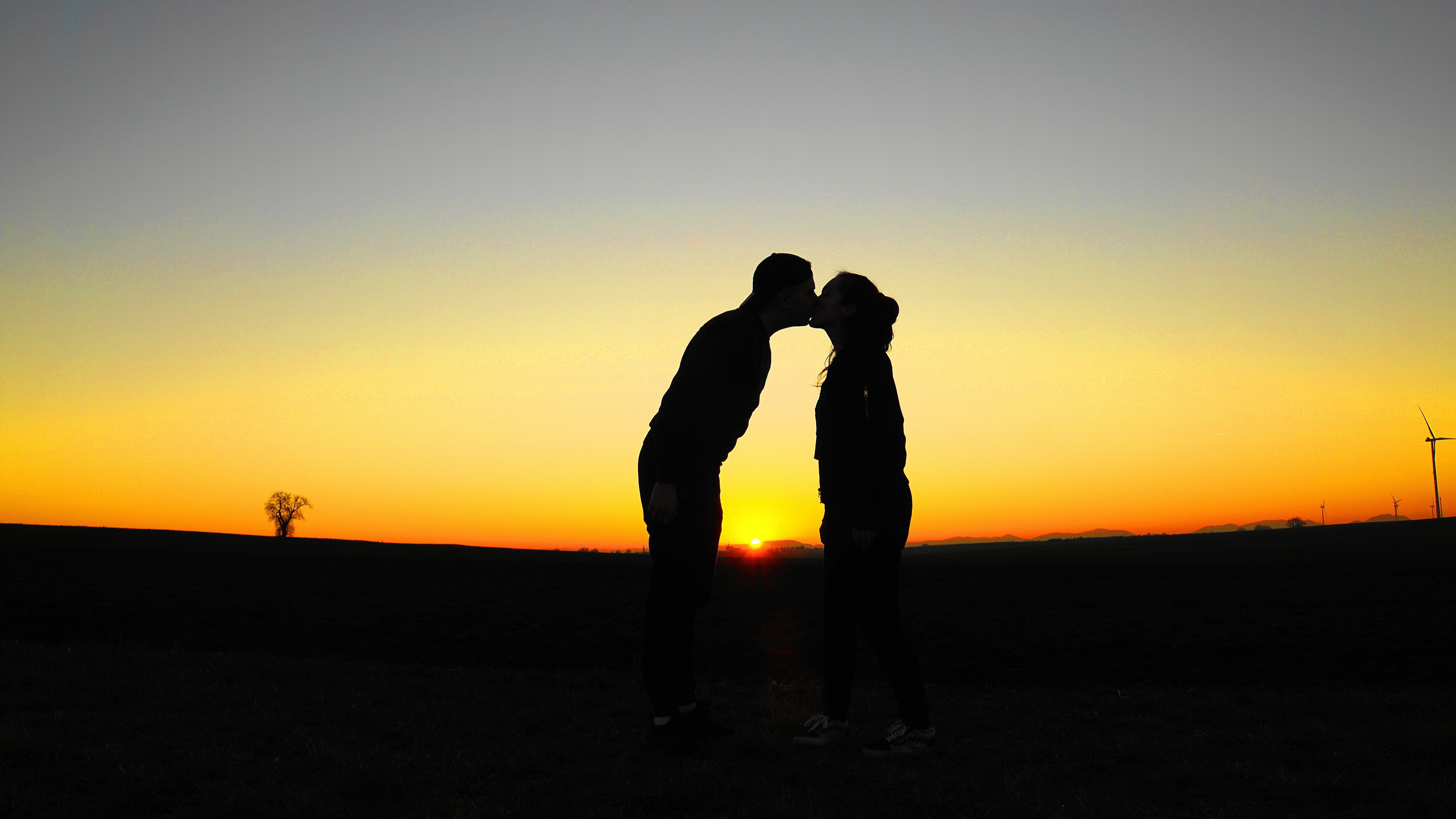 HD wallpaper, Horizon, Evening Sky, Silhouette, Romantic, Kissing Couple, Lovers, 5K, Sunset Orange, Together, Clear Sky