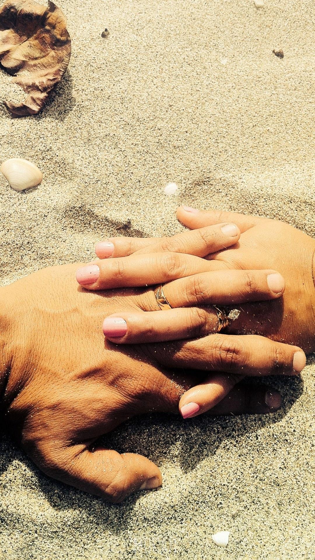 HD wallpaper, A Married Couple At The Beach Wearing Wedding Rings Holds Hands On The Sand, Lovers Hands On Sand, Huawei P9 Lite Background Hd, 1080X1920