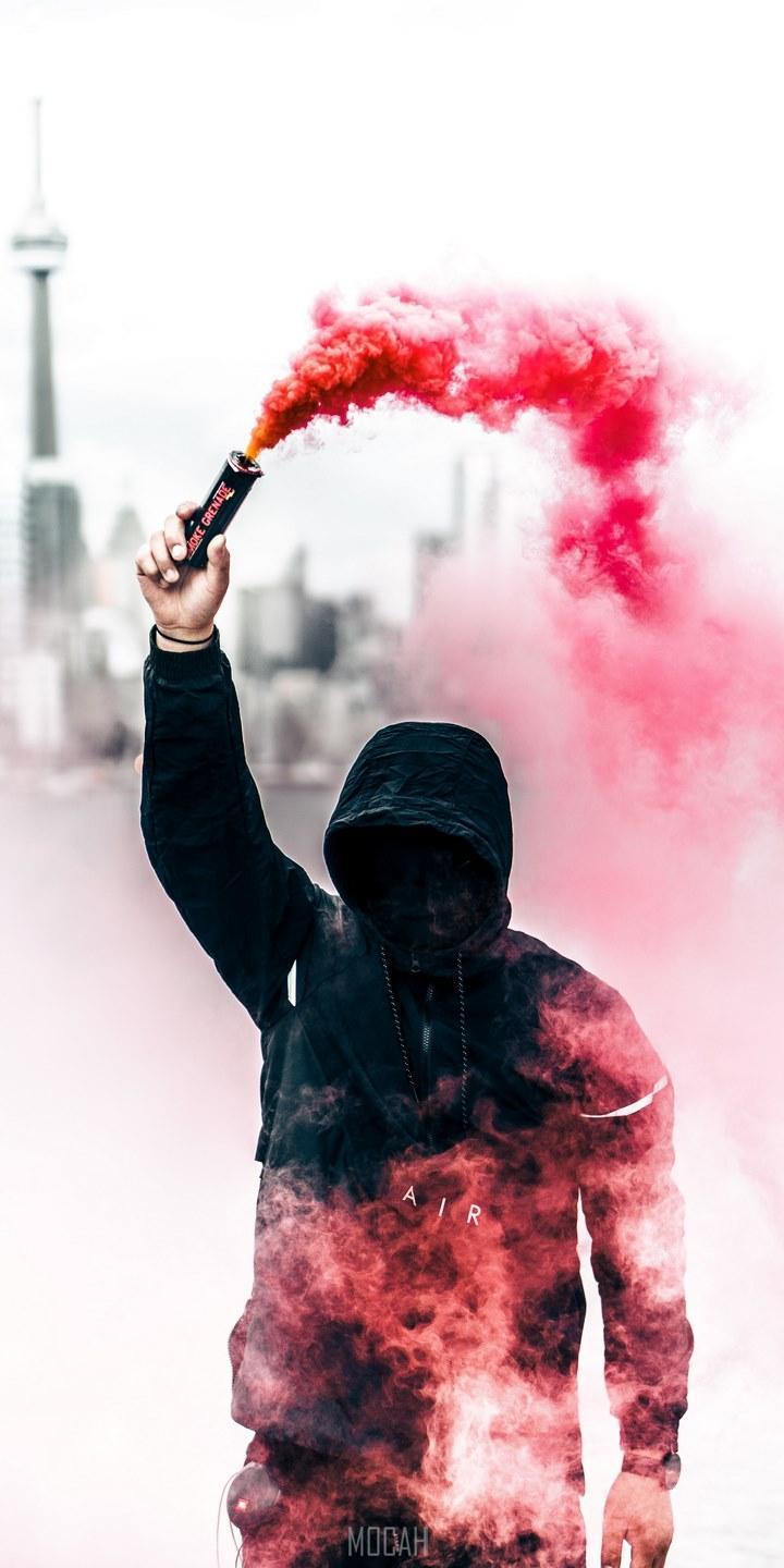 HD wallpaper, Panasonic Eluga Ray 550 Screensaver Hd, 720X1440, A Person In A Black Hoodie With Obscured Face Holds Up A Pink Smoke Grenade, Person With Pink Smoke Grenade