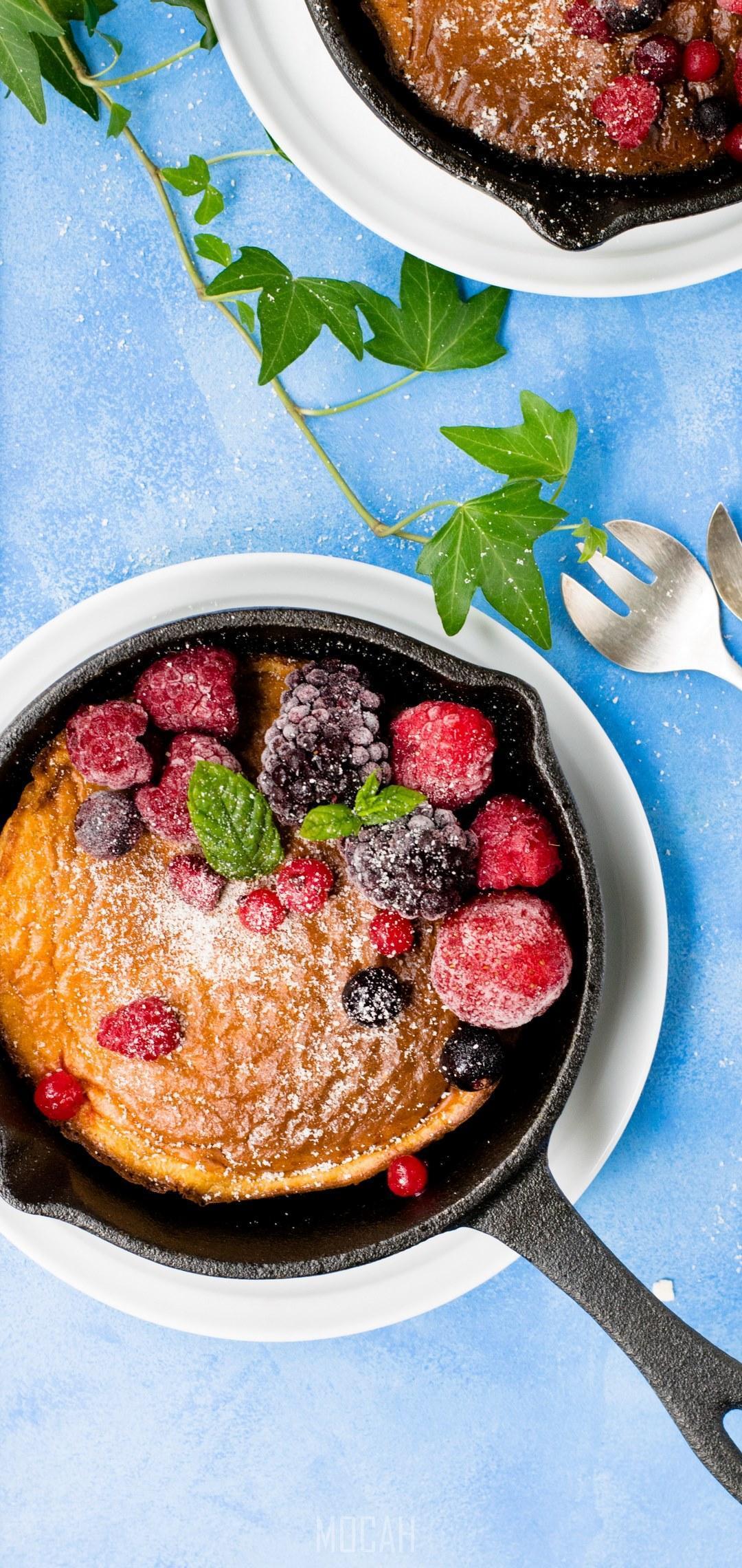 HD wallpaper, Dutch Baby Pancake, 1080X2280, Vivo V9 Wallpaper Free Download, Pancakes In Cast Iron Skillet With Berries And Blue Cloth