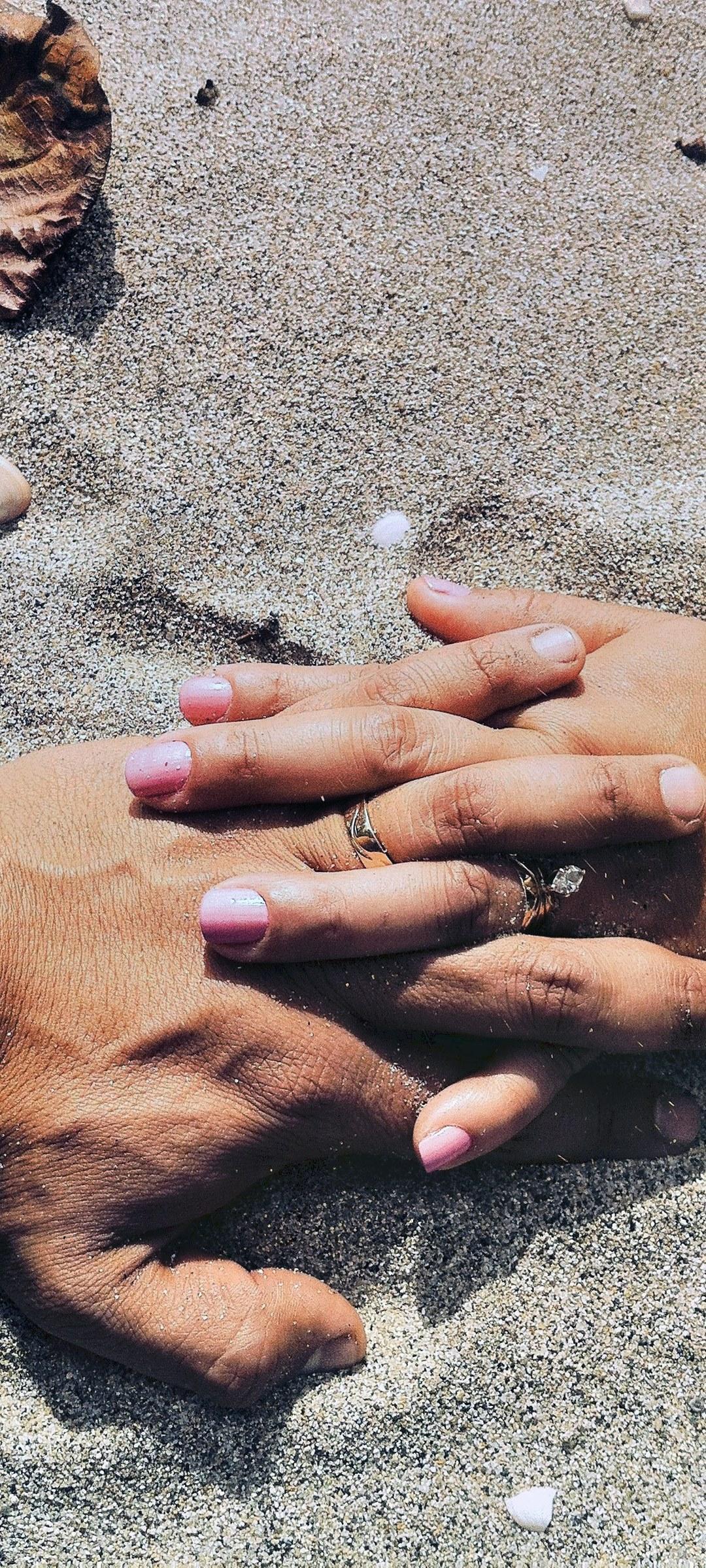HD wallpaper, Huawei Y9A Wallpaper Hd, 1080X2400, A Married Couple At The Beach Wearing Wedding Rings Holds Hands On The Sand, Lovers Hands On Sand